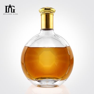 Garrafa de vidro de superfície lisa irregular redonda personalizada para produção de whisky de gin de 700 ml
