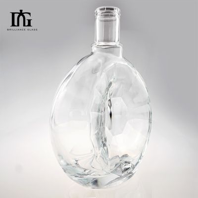Garrafa de vidro de superfície lisa irregular redonda personalizada para produção de whisky de gin de 700 ml